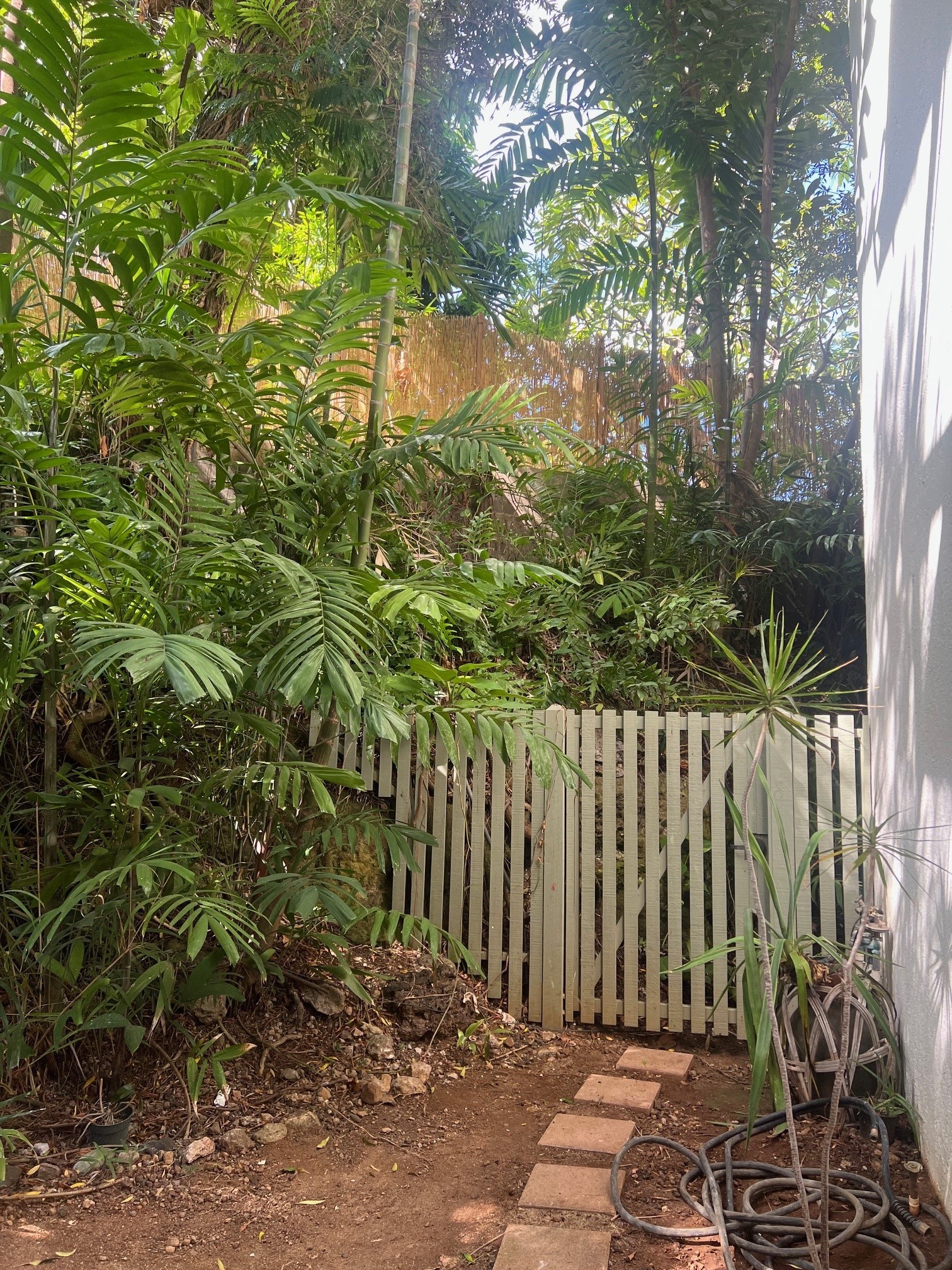 a white picket fence in front of a garden